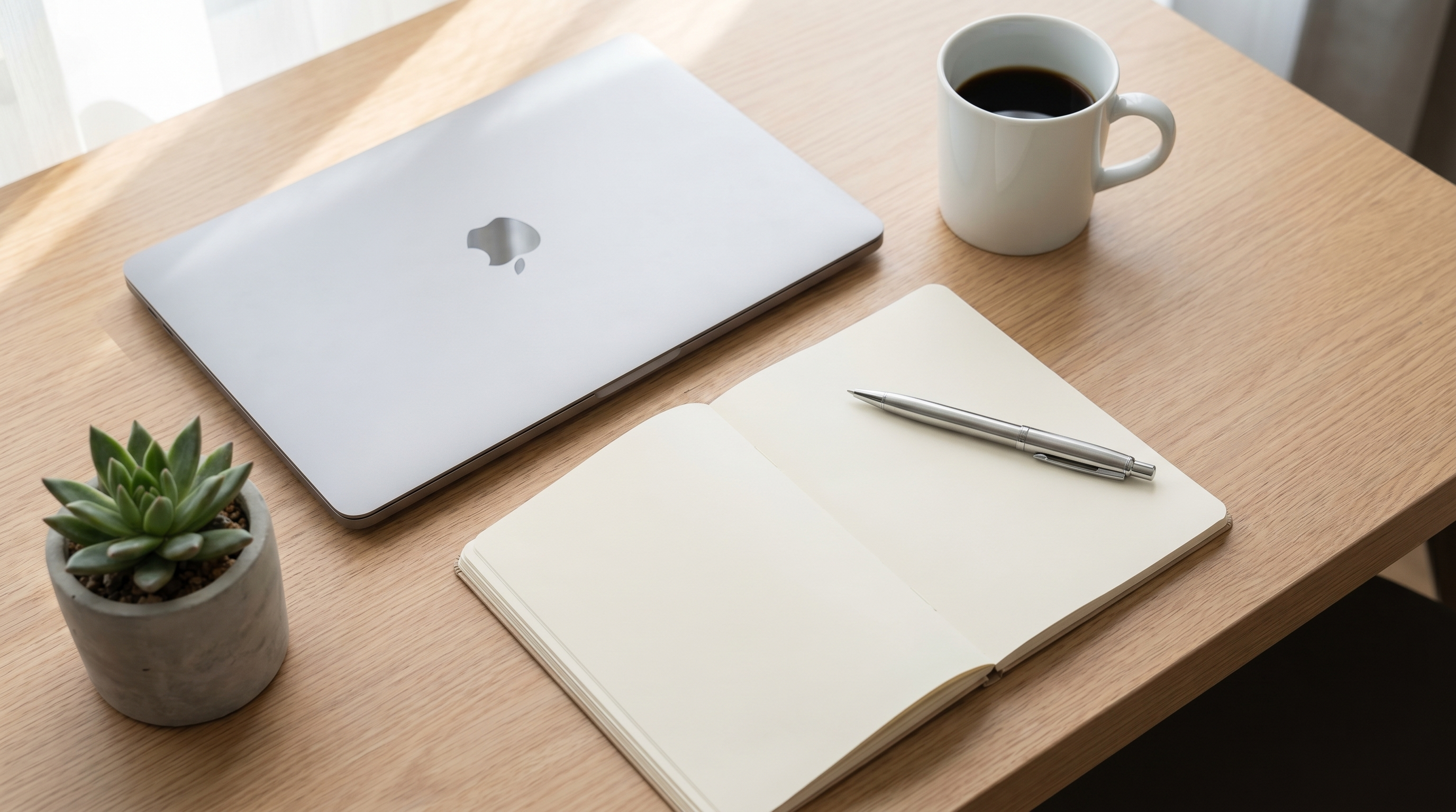 Clean workspace with laptop and notebook symbolising productivity and clear thinking